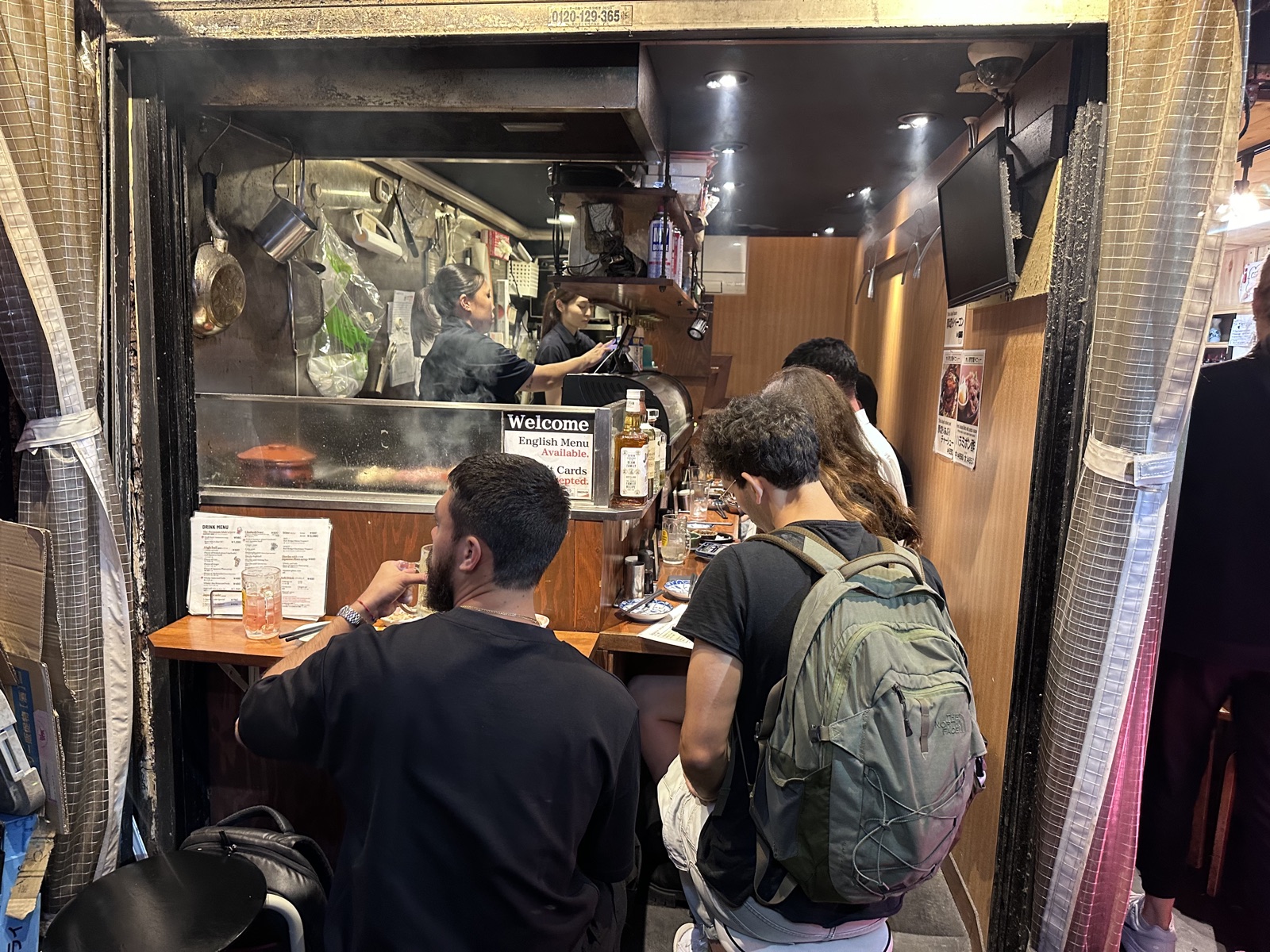 John at a counter restaurant in Japan